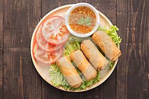 Fried Chinese traditional spring rolls on wooden background.