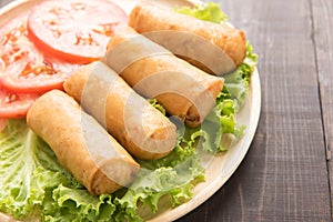 Fried Chinese traditional spring rolls on wooden table