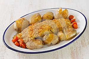 Fried cod with bread and potato on dish