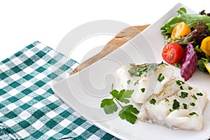 Fried cod fillet and salad in plate isolated