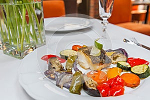 Fried cod with roasted vegetables.