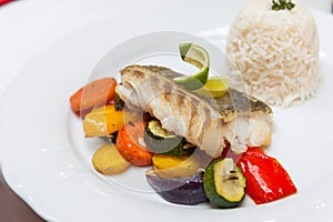 Fried cod with roasted vegetables.