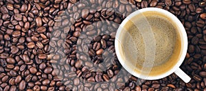 Fried coffee beans. Coffee mug on the background of coffee beans. Panorama, banner.
