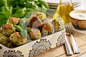 Fried crispy zucchini balls with feta cheese- vegetarian food.