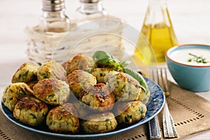 Fried crispy zucchini balls with feta cheese- vegetarian food.