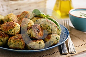 Fried crispy zucchini balls with feta cheese- vegetarian food.