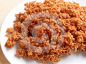 fried crispys pork in white bowl on white background