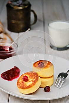 Fried curd pancakes - cheese pancakes on a plate. Healthy breakfast cheese pancakes traditional breakfast of Ukrainian and Russian