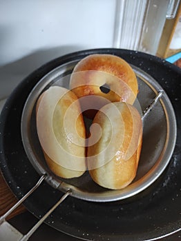 Fried doughnut on a drainer