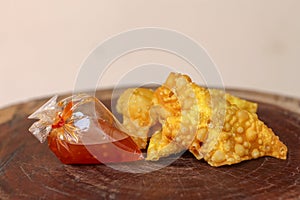 Fried dumplings,chinese food with sauce in plastic bag on wooden table