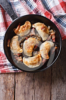 Fried dumplings in a pan close-up. vertical top view