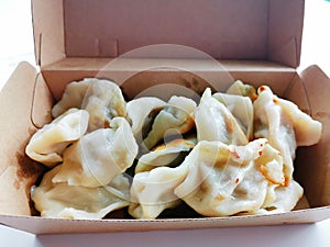 fried dumplings in a paper lunch box