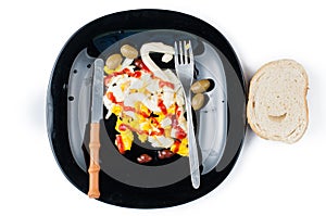 Fried egg on black plate isolated on white background.Eggs with kutchup,olives and bread