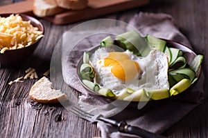 Fried egg and bread on wooden table
