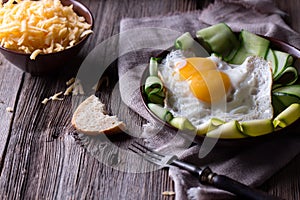 Fried egg and bread on wooden table