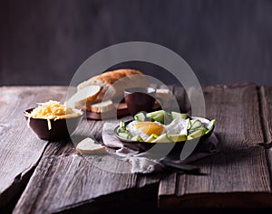 Fried egg and bread on wooden table