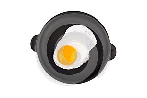 Fried egg on frying pan, top view. Isolated on white background.