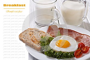 Fried egg with ham, tomatoes and fresh milk