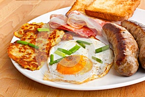 Fried egg, hash browns and bacon breakfast photo
