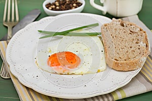 Fried egg heart with onion and bread