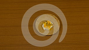 fried egg, with hen drawn, hard-boiled egg with yellow yolk coming out on the cutting board photo