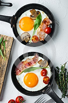 Fried Egg with ingredients in cast iron frying pan, on white background, top view flat lay