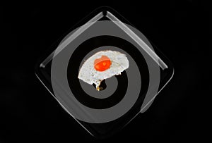 Fried egg isolated on black background