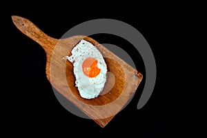 Fried egg isolated on black background