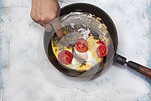Fried egg pan. Breakfast with fried eggs and vegetables
