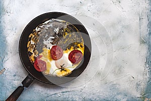 Fried egg pan. Breakfast with fried eggs and vegetables
