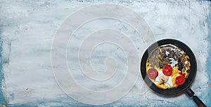 Fried egg pan. Breakfast with fried eggs and vegetables