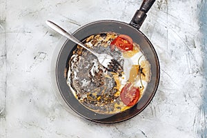 Fried egg pan. Breakfast with fried eggs and vegetables