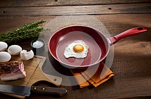 Fried egg in red frying pan