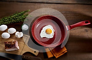 Fried egg in red frying pan photo