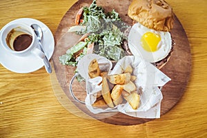 Fried egg and salad. Egg salad sandwich with French fries. The salad with homemade baked French fries, grilled steal hard-boiled