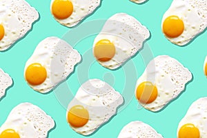 Fried egg or scrambled eggs pattern on blue background. Creative food concept. Top view. Conceptual trend. Banner. Keto diet.