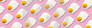 Fried egg or scrambled eggs pattern on pink background. Creative food concept. Top view. Conceptual trend. Banner. Keto diet.