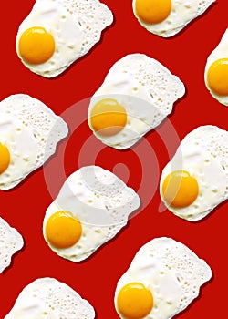 Fried egg or scrambled eggs pattern on red background. Creative food concept. Top view. Conceptual trend. Banner. Keto diet.