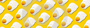 Fried egg or scrambled eggs pattern on yellow background. Creative food concept. Top view. Conceptual trend. Banner. Keto diet.