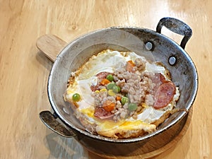 Fried egg served on pan or Indochina pan-fried egg with topping