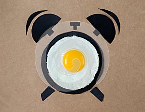 Fried egg in shape of alarm clock, breakfast time concept