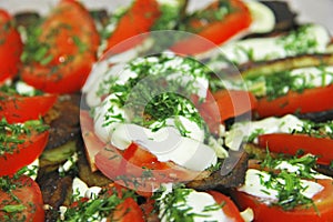 Fried eggplants and fresh tomato with souce and herbs