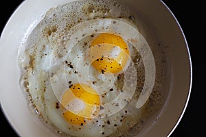 Fried eggs from 2 eggs in a frying pan. Hot Sunny dish