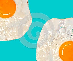 Fried eggs on blue background. Protein-rich breakfast foods.