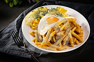 Fried eggs with boiled potatoes and yellow string beans