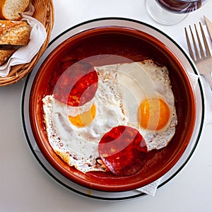 Fried eggs with dry cured sausage