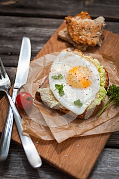 Fried eggs and fresh bread with cherry tomatoes, herbs and spices for breakfast