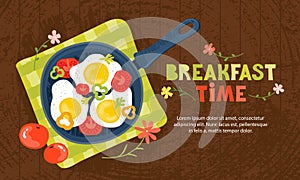 Fried eggs in a frying pan with vegetables, tomatoes, peppers. Healthy brunch with fresh homemade meal on a wooden table.