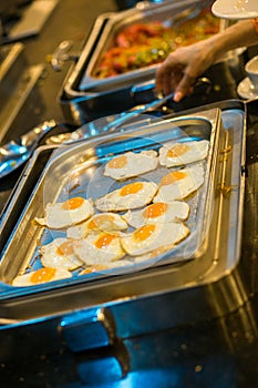 Fried eggs, a lot. The process of preparing breakfast in the buffet restaurant