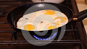 Fried eggs in a pan. Shooting at 480 frames per second. Broken egg falls into the frying pan. HD